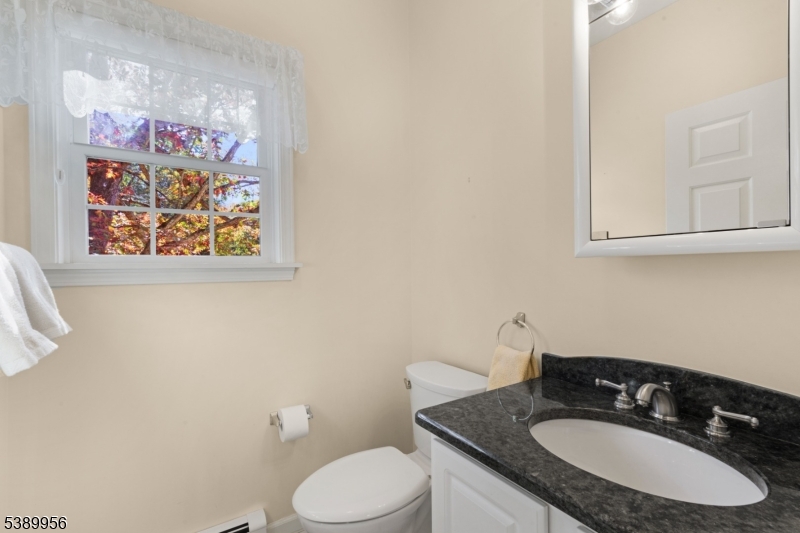 3 Hidden Hills Road Oak Ridge, NJ 07438 - Photo 16 of 32 a bathroom with a granite countertop toilet sink and mirror