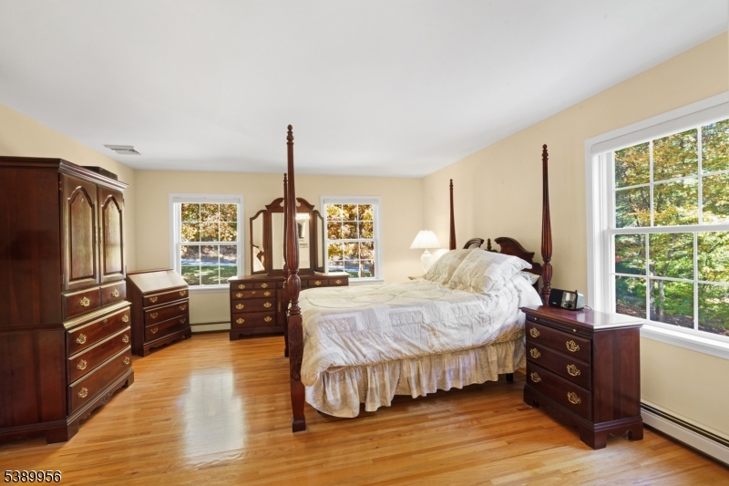 3 Hidden Hills Road Oak Ridge, NJ 07438 - Photo 17 of 32 a bed room with a bed and a dresser