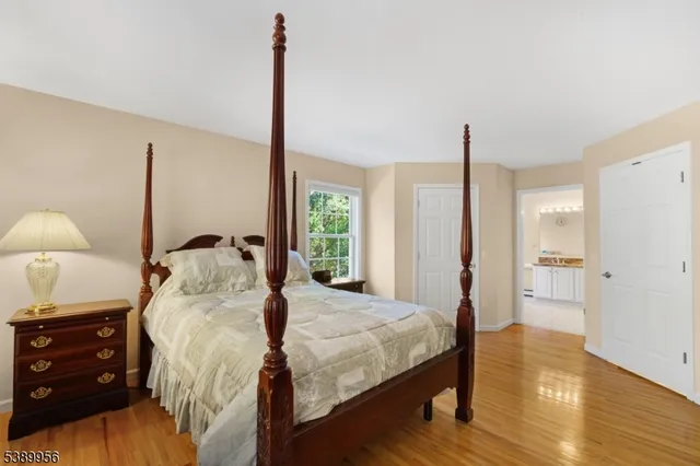 a bedroom with a bed and a lamp