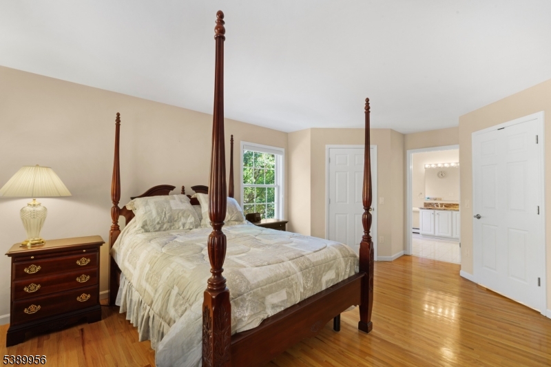 3 Hidden Hills Road Oak Ridge, NJ 07438 - Photo 18 of 32 a bedroom with a bed and a lamp