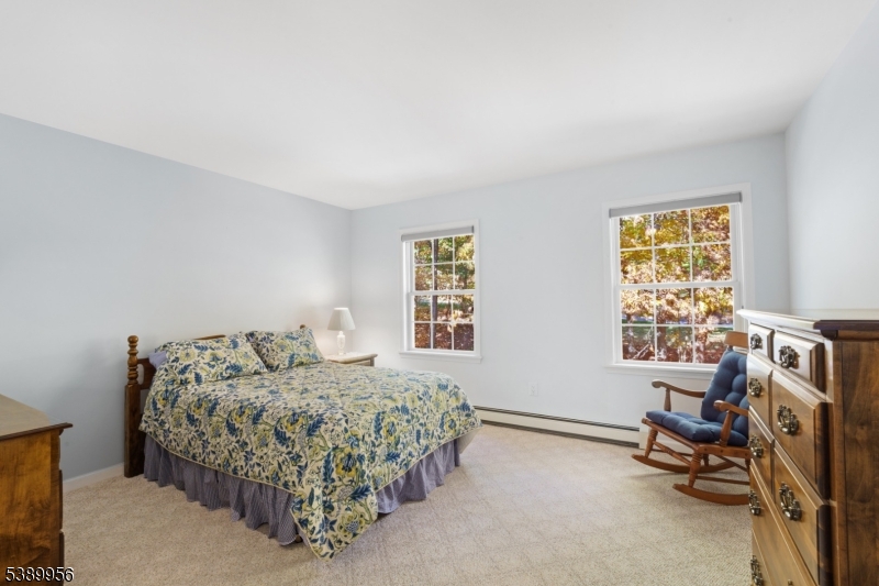 3 Hidden Hills Road Oak Ridge, NJ 07438 - Photo 21 of 32 a bedroom with a bed a table and a window