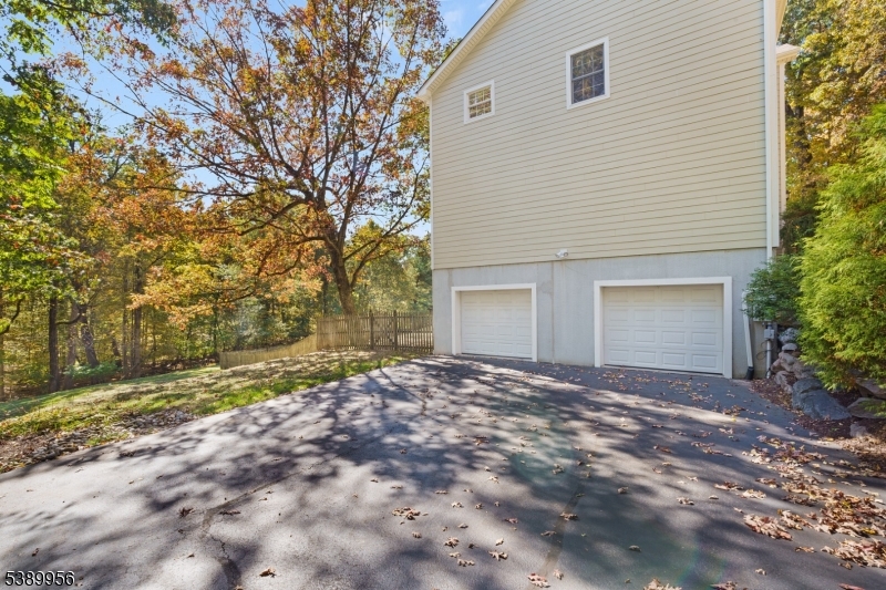 3 Hidden Hills Road Oak Ridge, NJ 07438 - Photo 27 of 32 a view of a house with a yard and garage