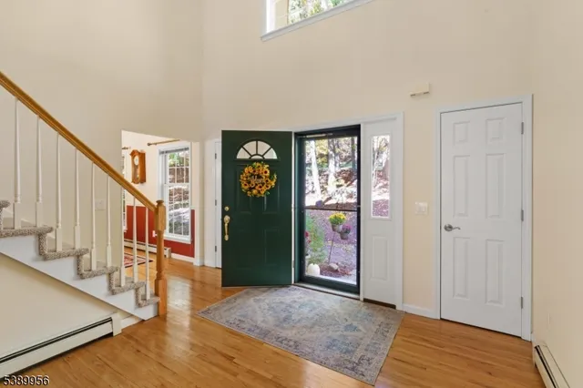 a view of an entryway with wooden floor and windows