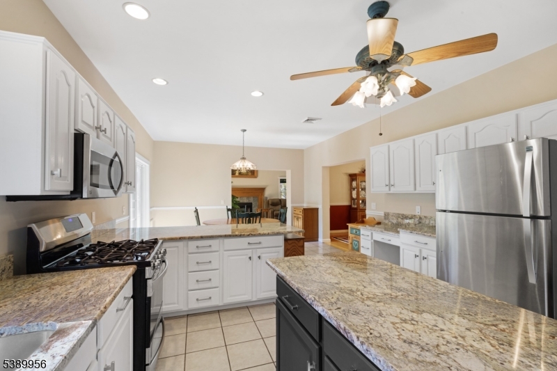 3 Hidden Hills Road Oak Ridge, NJ 07438 - Photo 6 of 32 a kitchen with stainless steel appliances granite countertop a sink stove and refrigerator
