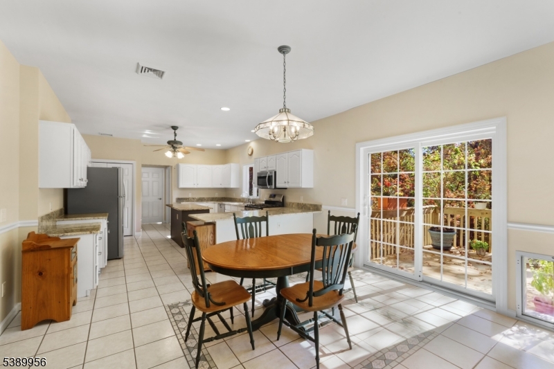 3 Hidden Hills Road Oak Ridge, NJ 07438 - Photo 9 of 32 a view of a dining room with furniture and a chandelier