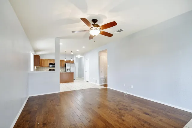 a view of a kitchen with kitchen island wooden floors wooden floor and center island