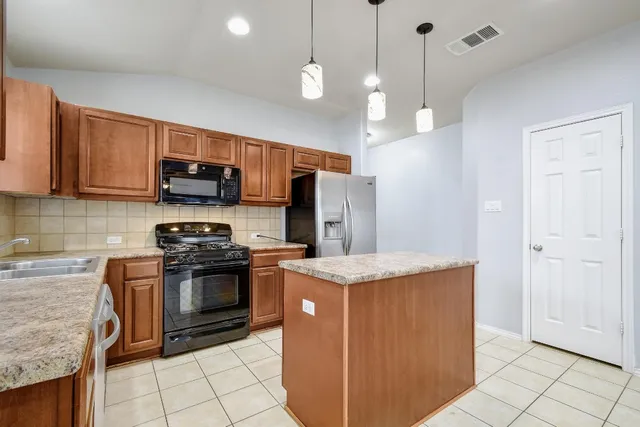 a kitchen with a sink stove and cabinets
