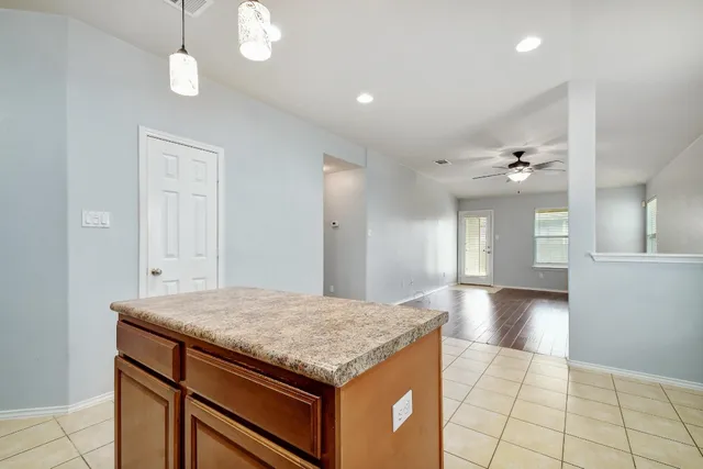 a kitchen with stainless steel appliances granite countertop a refrigerator and a stove top oven