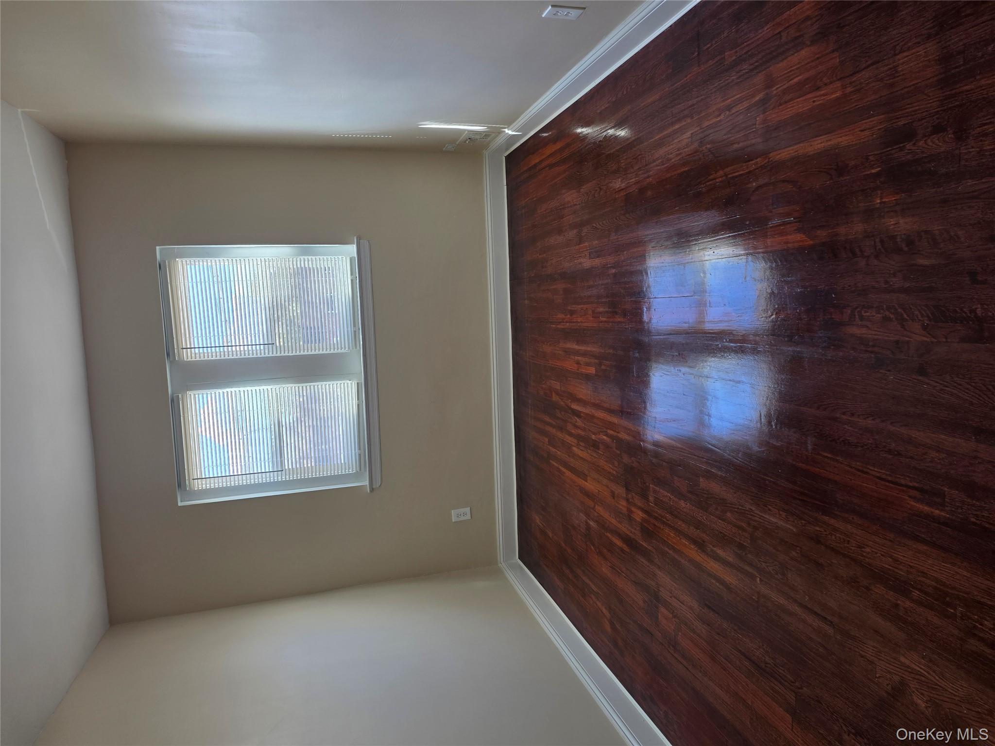 4160 Baychester Avenue Bronx, NY 10466 - Photo 14 of 24 an empty room with wooden floor and windows