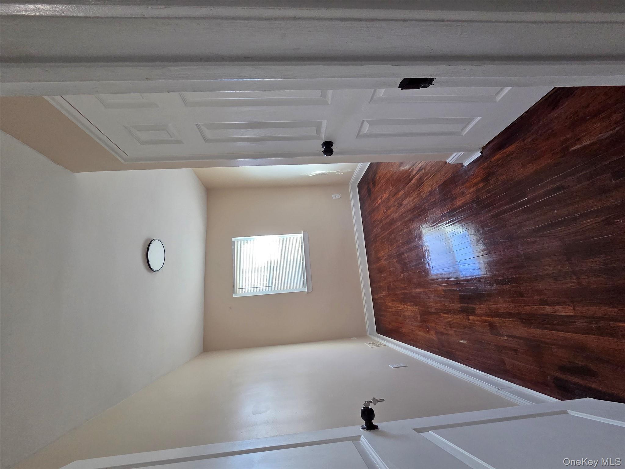 4160 Baychester Avenue Bronx, NY 10466 - Photo 17 of 24 an empty room with wooden floor and a window