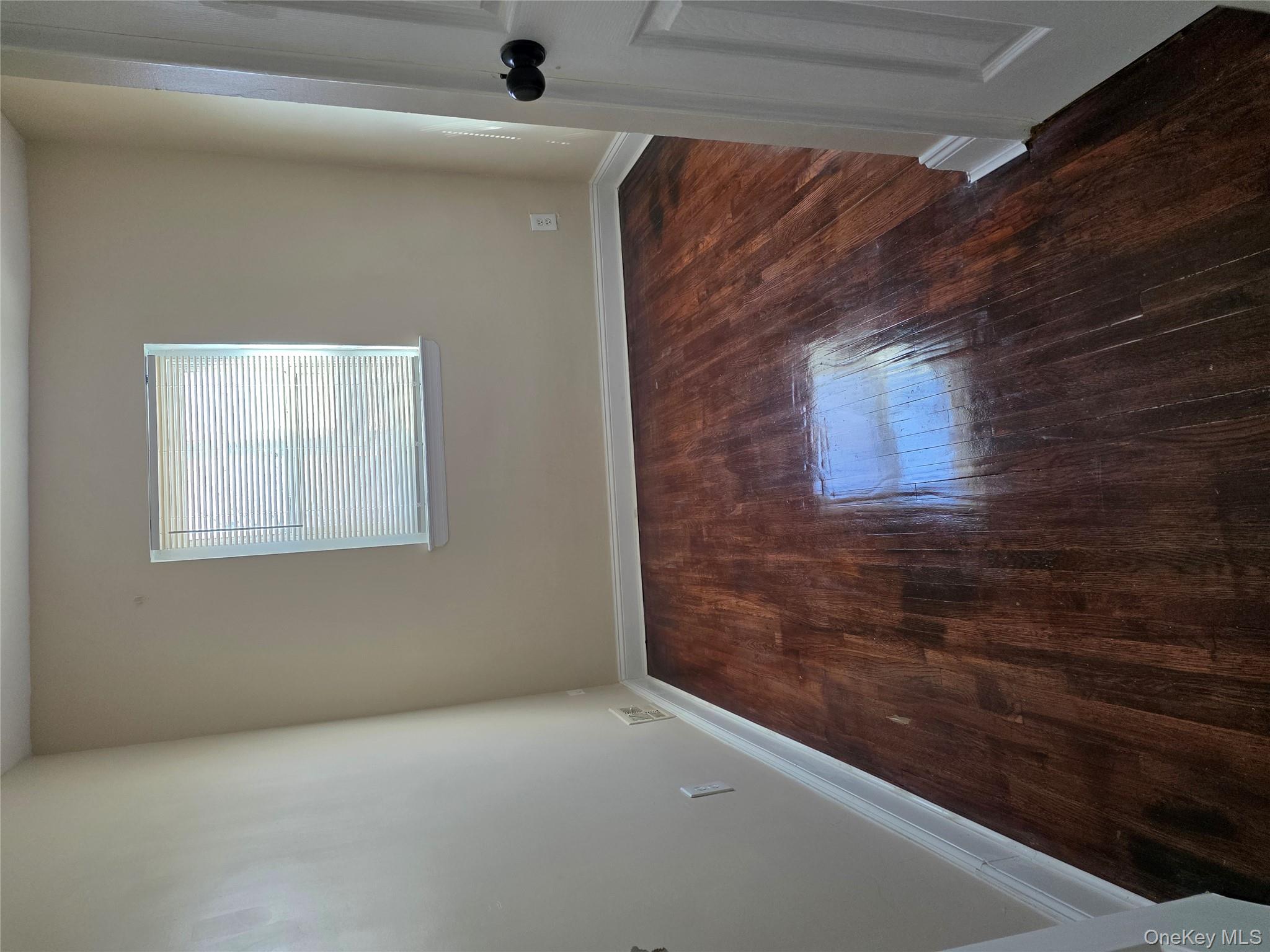 4160 Baychester Avenue Bronx, NY 10466 - Photo 19 of 24 a view of a room with wooden floor and window