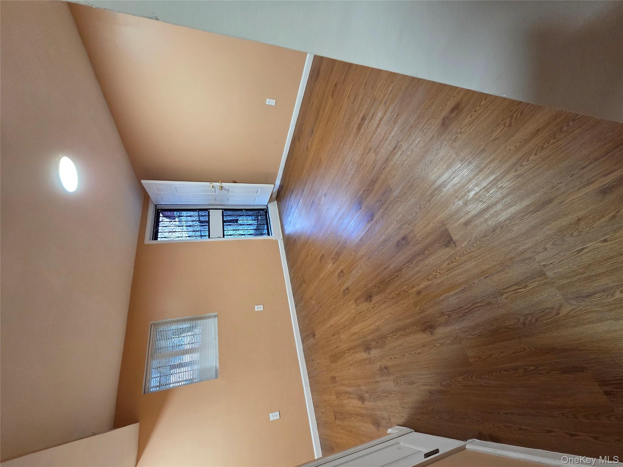 4160 Baychester Avenue Bronx, NY 10466 - Photo 24 of 24 an empty room with wooden floor and windows