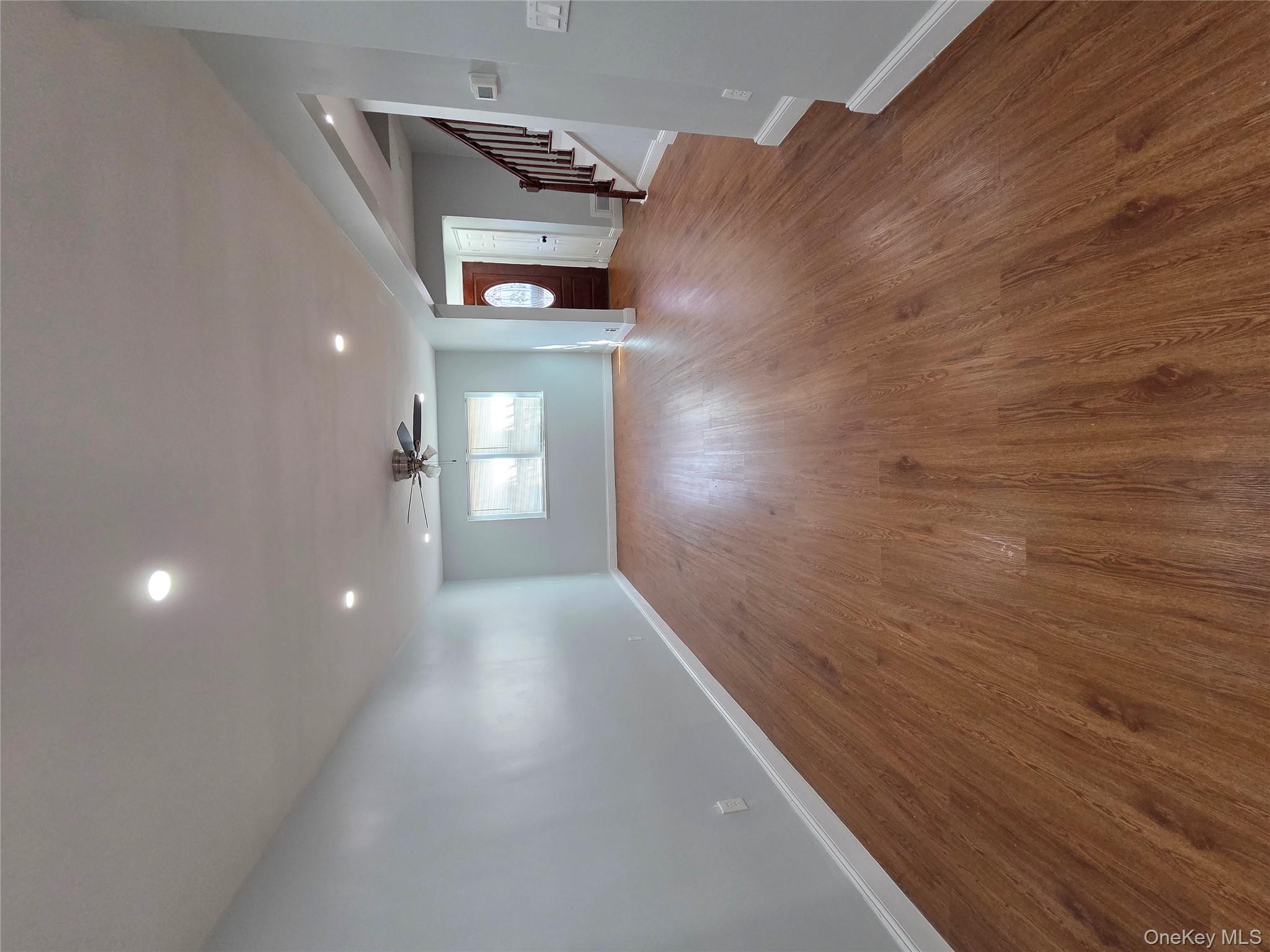 4160 Baychester Avenue Bronx, NY 10466 - Photo 5 of 24 an empty room with wooden floor and windows