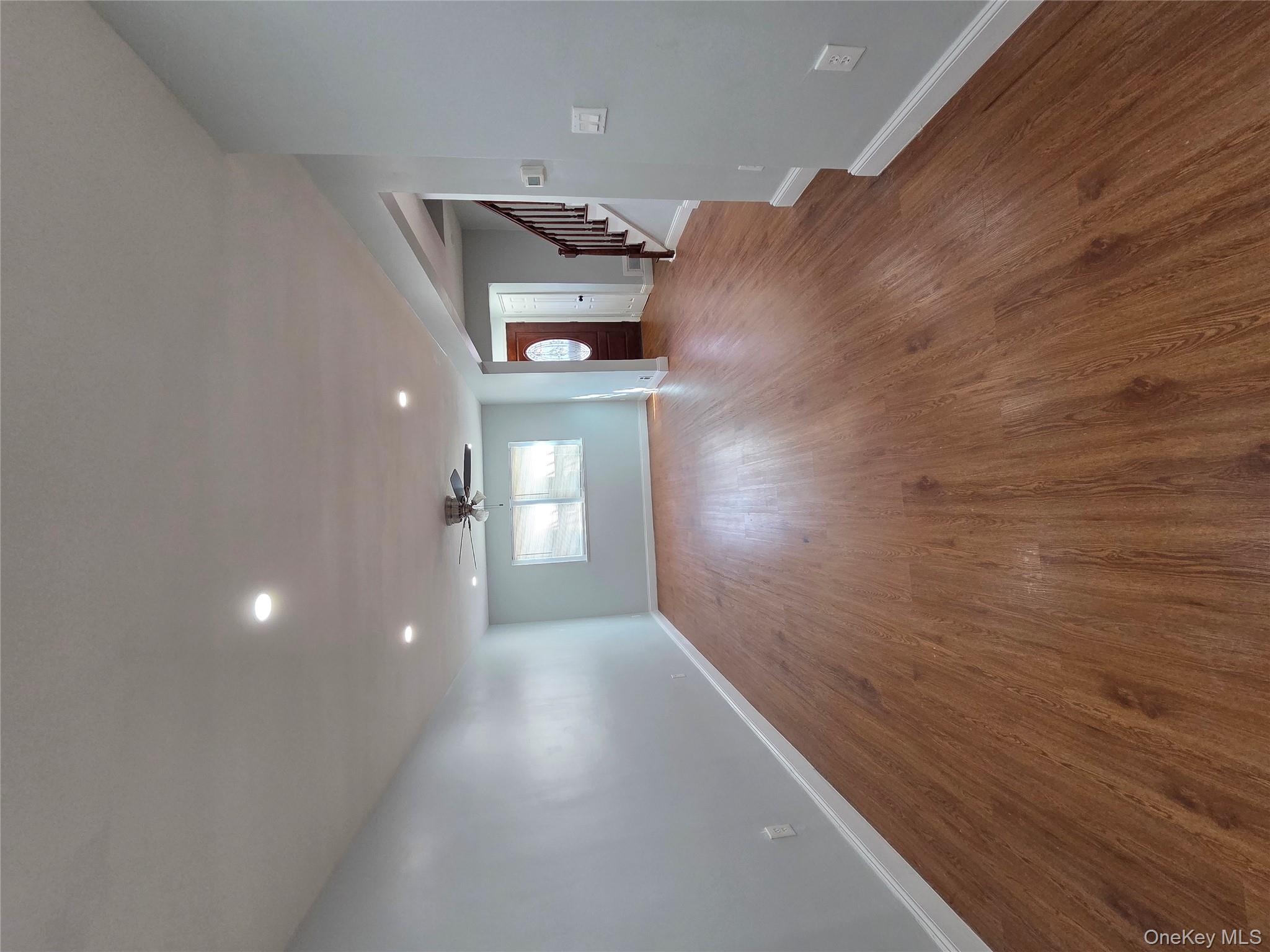 4160 Baychester Avenue Bronx, NY 10466 - Photo 7 of 24 a view of a big room with wooden floor and windows