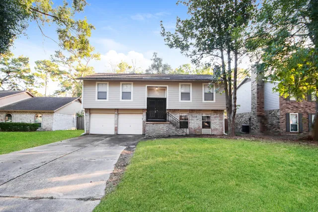 a view of a house with a yard and tree s
