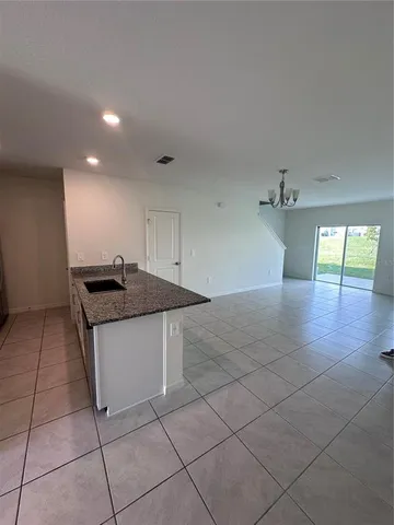 a view of a kitchen with a sink and a stove top oven