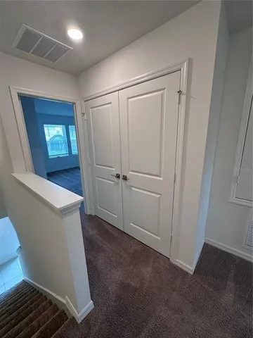 a view of a hallway with closet area
