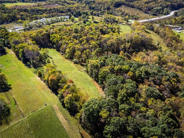 an aerial view of a houses with a yard