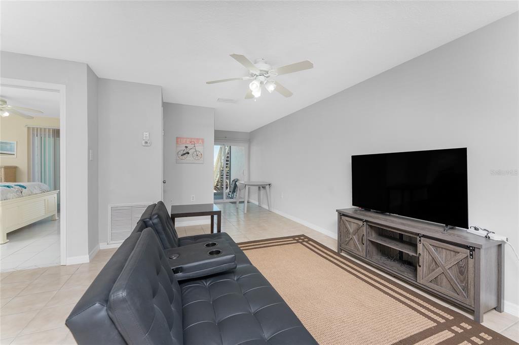 5041 North Beach Road, Unit 2A AND 2B Englewood, FL 34223 - Photo 12 of 90 a living room with furniture and a flat screen tv