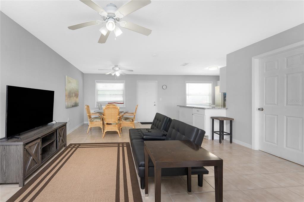 5041 North Beach Road, Unit 2A AND 2B Englewood, FL 34223 - Photo 16 of 90 a living room with furniture and a flat screen tv