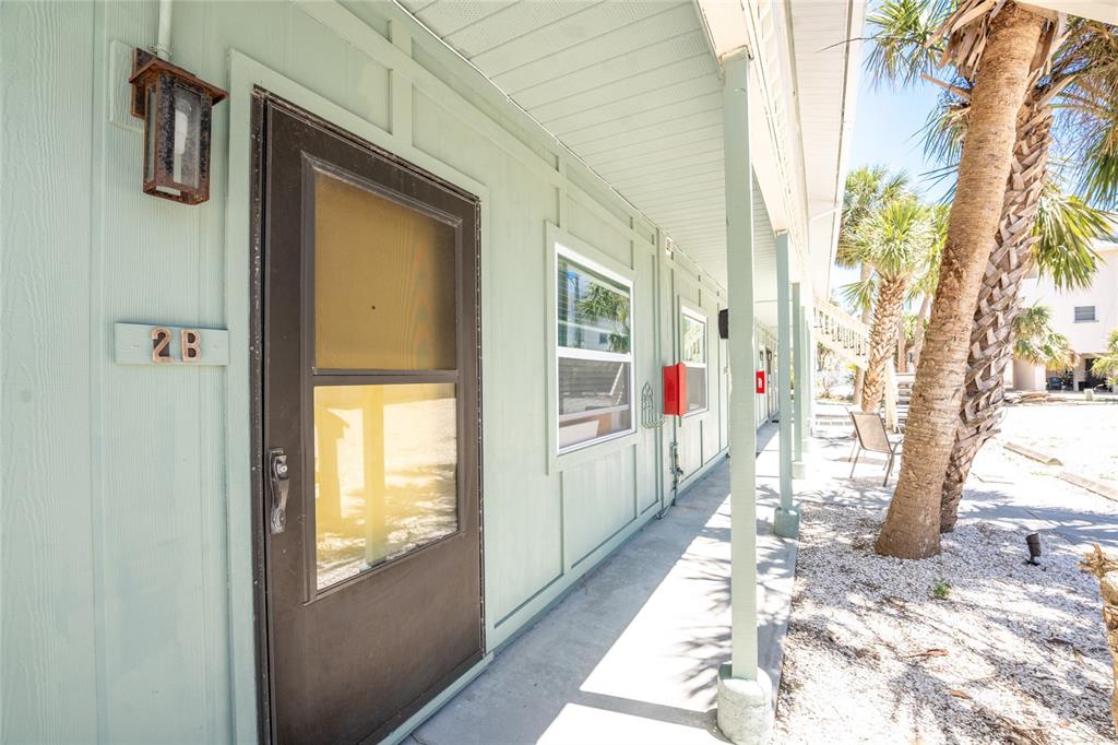 5041 North Beach Road, Unit 2A AND 2B Englewood, FL 34223 - Photo 2 of 90 a front view of a house with a porch