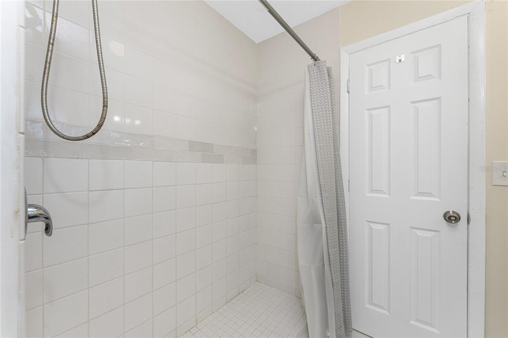 5041 North Beach Road, Unit 2A AND 2B Englewood, FL 34223 - Photo 24 of 90 a bathroom with a glass shower door