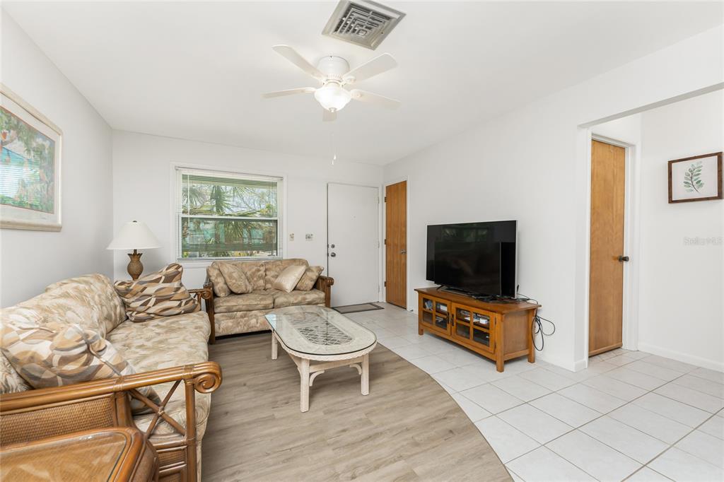 5041 North Beach Road, Unit 2A AND 2B Englewood, FL 34223 - Photo 33 of 90 a living room with furniture and a flat screen tv