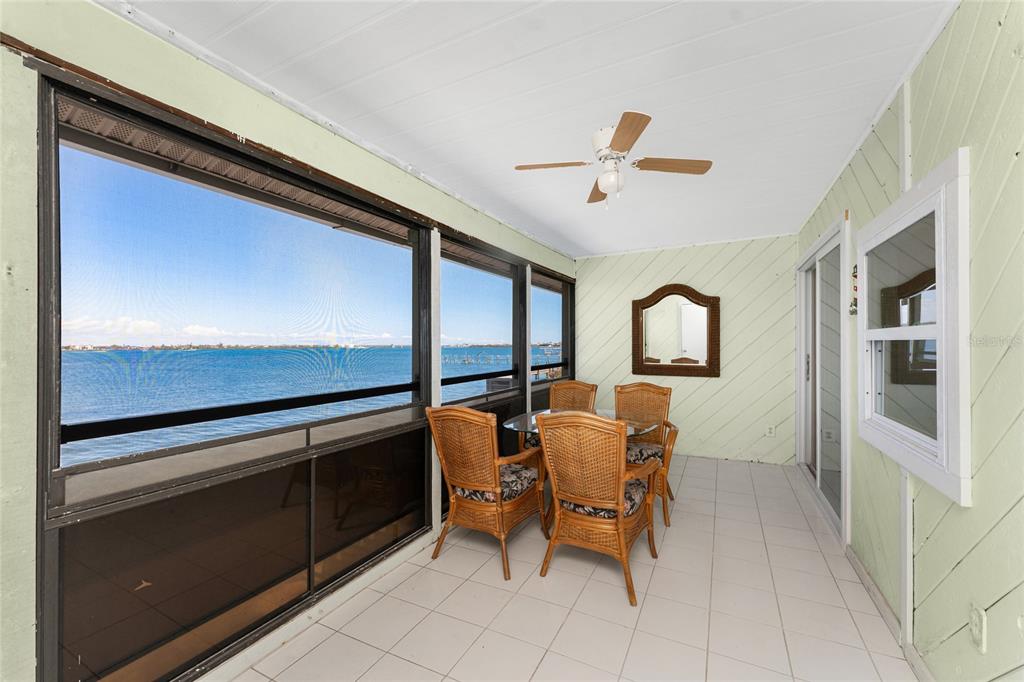 5041 North Beach Road, Unit 2A AND 2B Englewood, FL 34223 - Photo 44 of 90 a dining room with furniture and a window