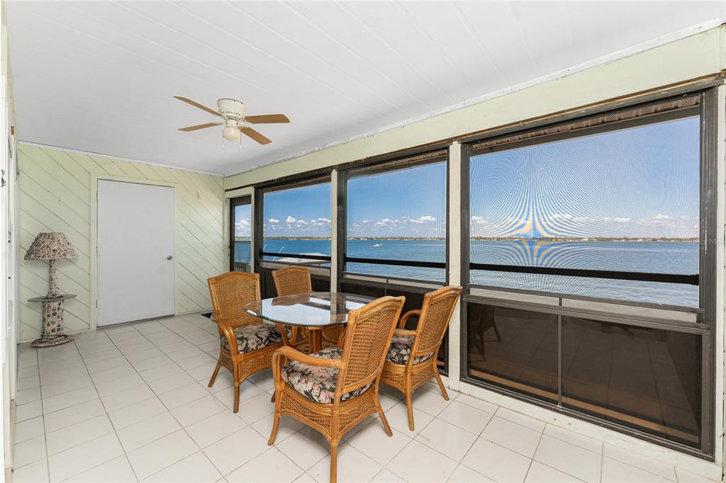 5041 North Beach Road, Unit 2A AND 2B Englewood, FL 34223 - Photo 45 of 90 a dining room with furniture and a floor to ceiling window