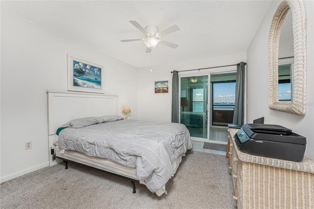 5041 North Beach Road, Unit 2A AND 2B Englewood, FL 34223 - Photo 49 of 90 a bedroom with a bed and a large window