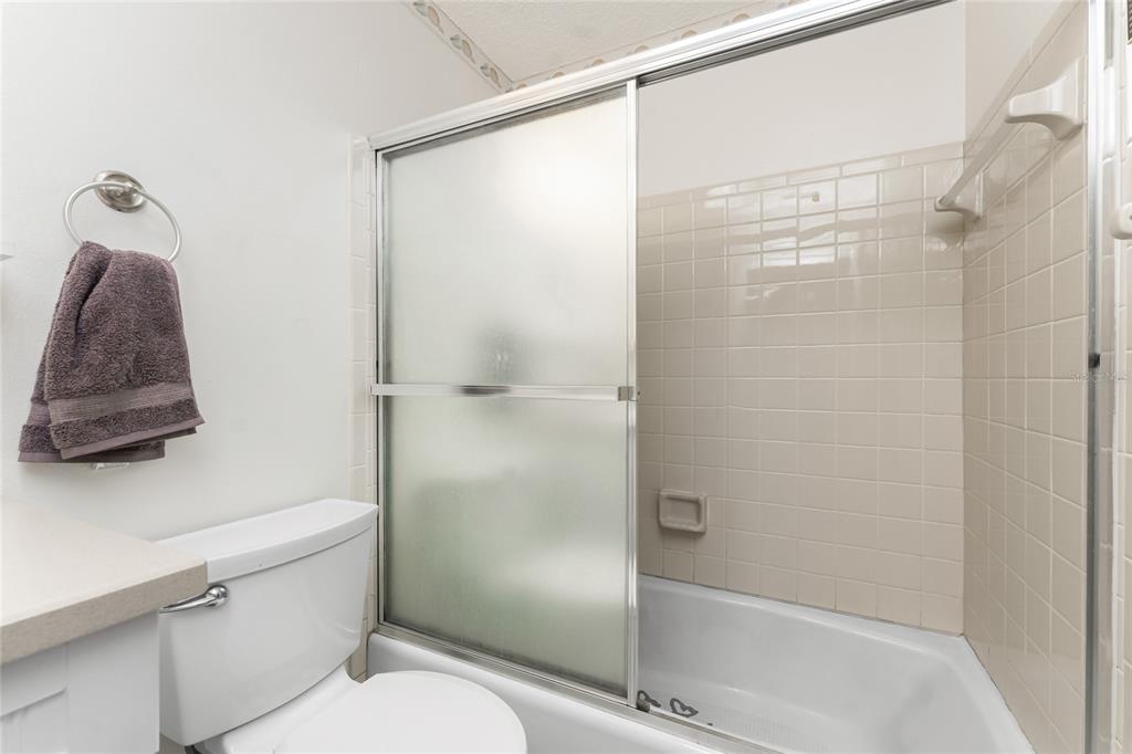5041 North Beach Road, Unit 2A AND 2B Englewood, FL 34223 - Photo 52 of 90 a bathroom that has a glass shower door
