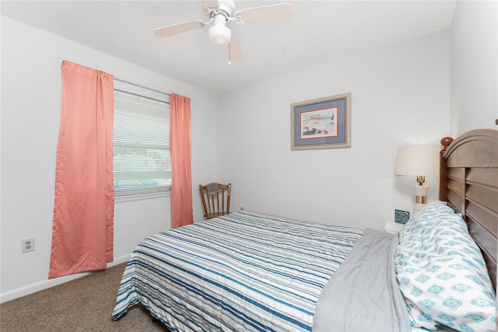 5041 North Beach Road, Unit 2A AND 2B Englewood, FL 34223 - Photo 54 of 90 a bedroom with a bed and a chandelier