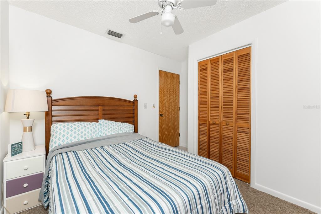 5041 North Beach Road, Unit 2A AND 2B Englewood, FL 34223 - Photo 56 of 90 a bedroom with a bed and a walk in closet