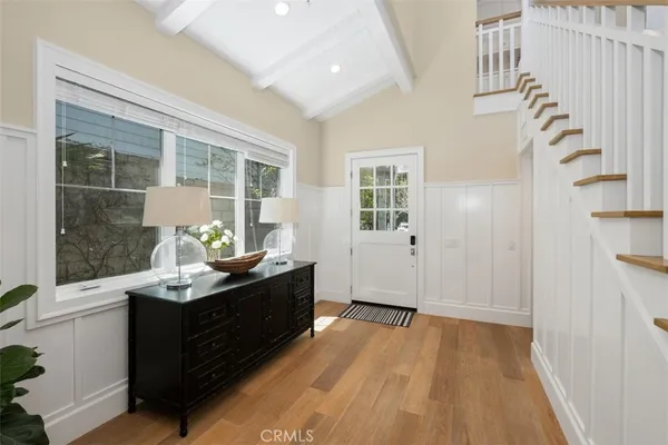 a view of a sink and an entryway with wooden floor