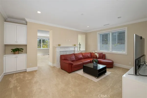 a living room with furniture window and a flat screen tv