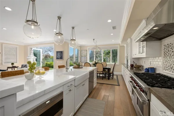 a kitchen with sink stove and cabinets