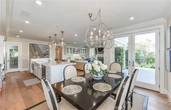 a very nice looking dining room with furniture large window and wooden floor