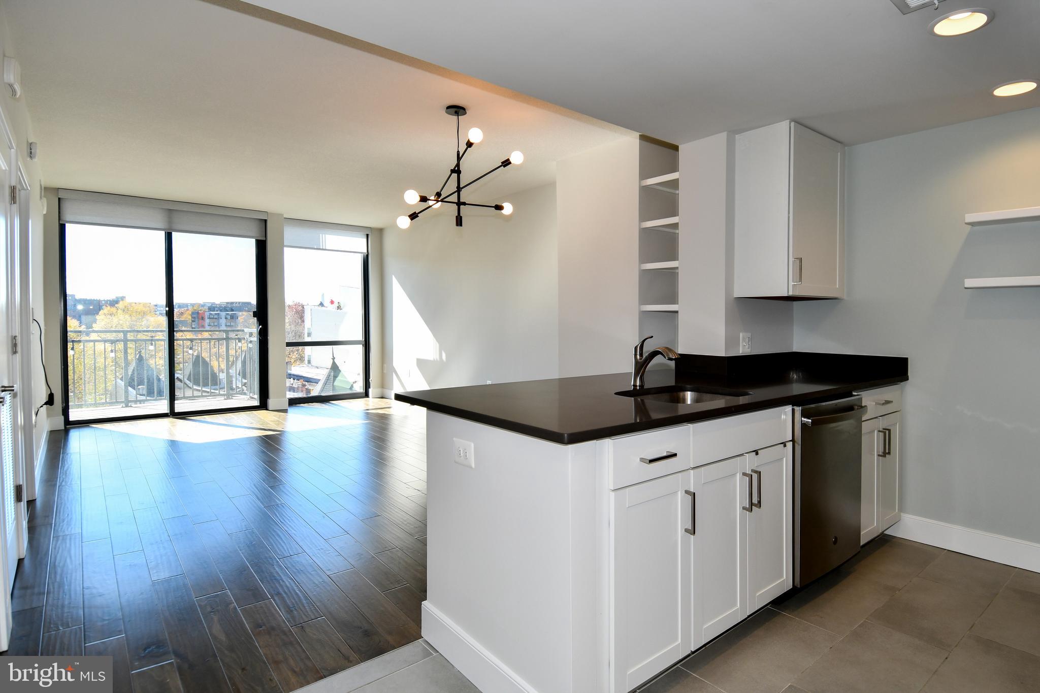 a kitchen with granite countertop a sink and cabinets