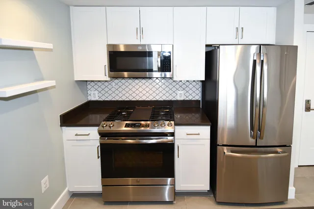 a kitchen with a stove and a microwave