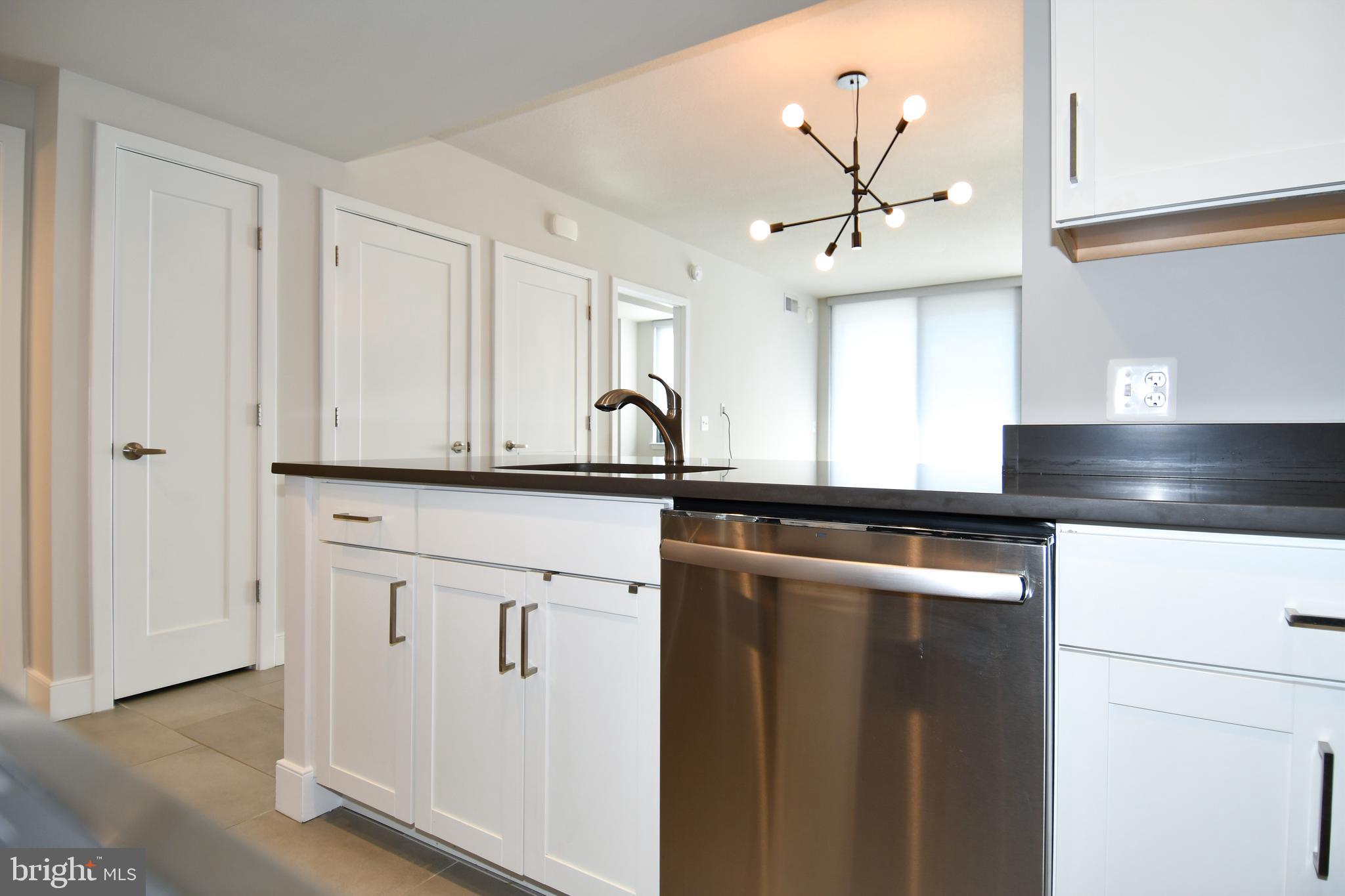 50 Florida Avenue Northeast, Unit 523 Washington, DC 20002 - Photo 14 of 38 a kitchen with stainless steel appliances granite countertop a sink and a refrigerator