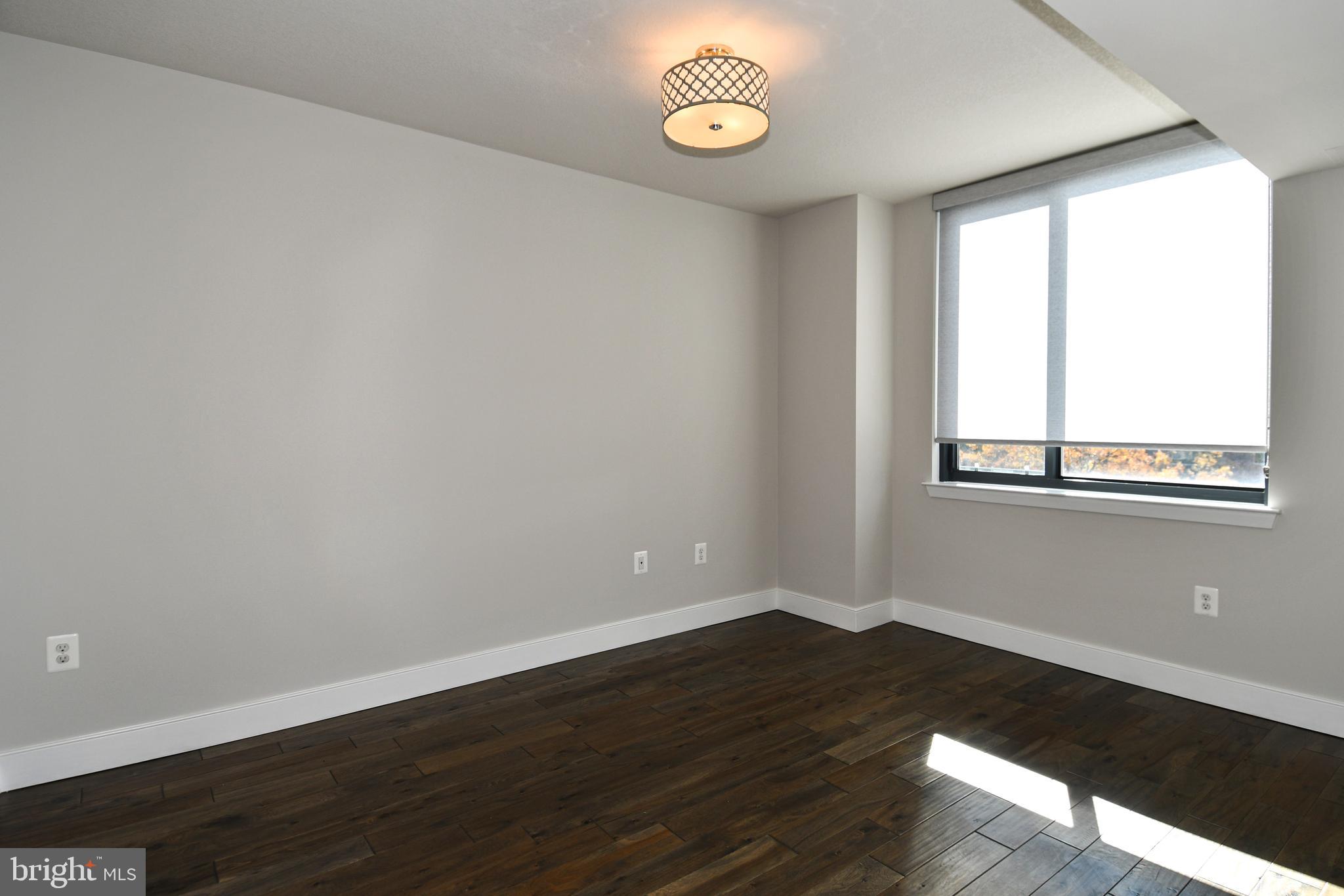 50 Florida Avenue Northeast, Unit 523 Washington, DC 20002 - Photo 18 of 38 a view of an empty room with wooden floor and a window