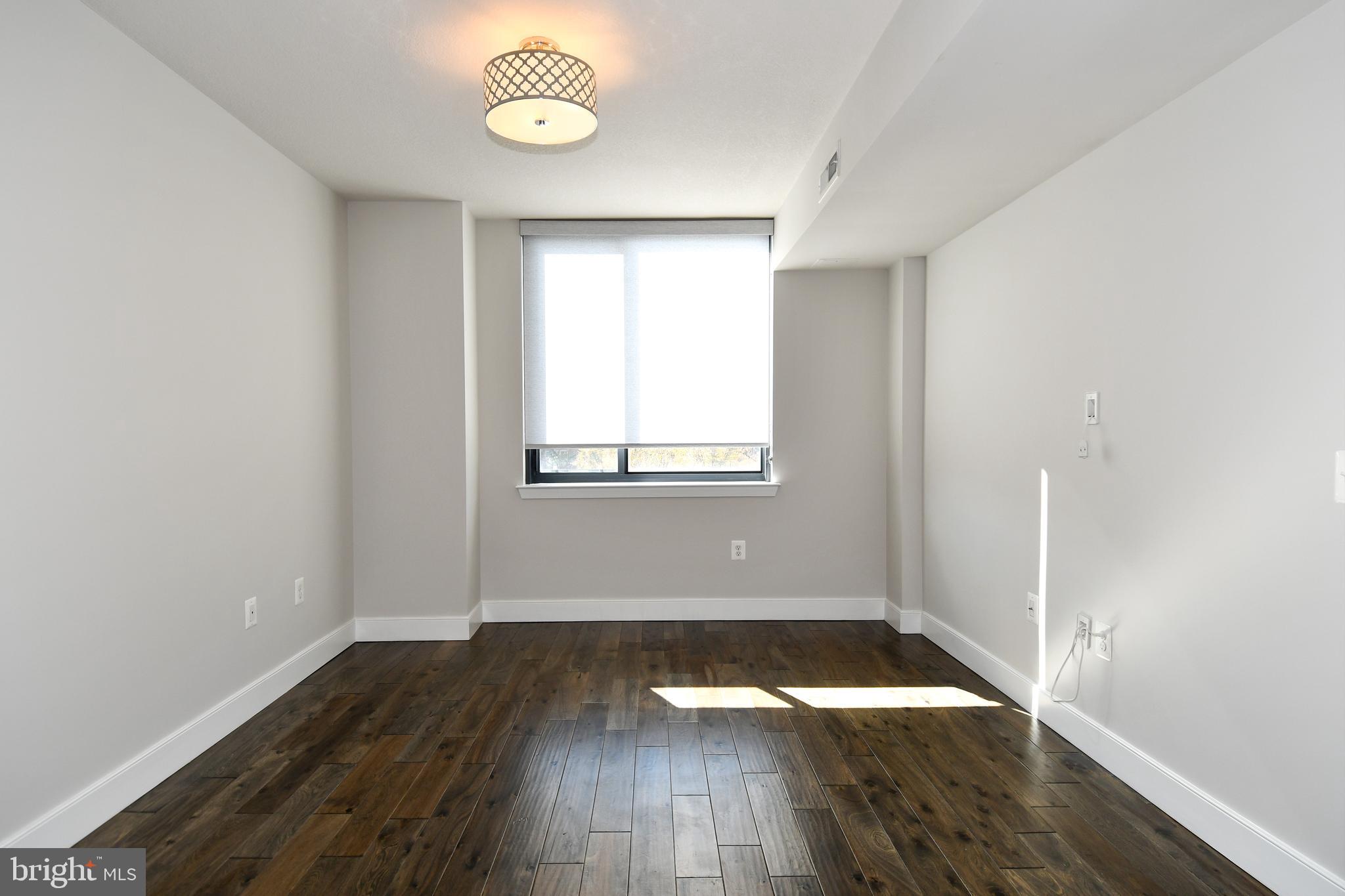 50 Florida Avenue Northeast, Unit 523 Washington, DC 20002 - Photo 19 of 38 an empty room with wooden floor and windows