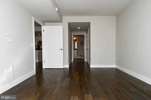 an empty room with wooden floor and closet