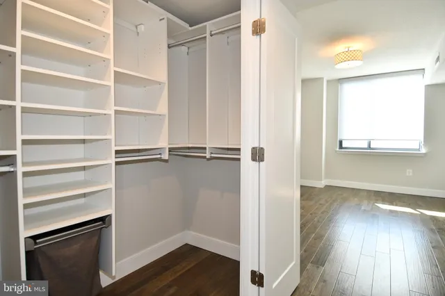 a view of walk in closet with empty racks