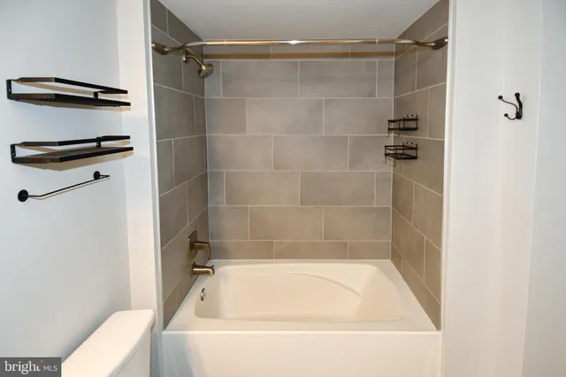 a bathroom with a bathtub and a shower