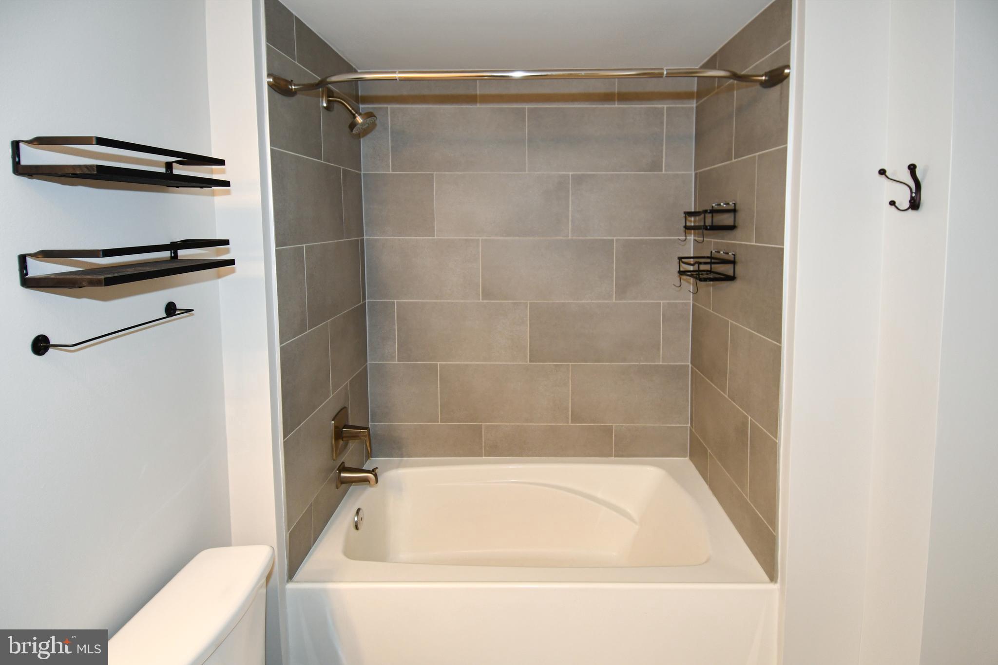50 Florida Avenue Northeast, Unit 523 Washington, DC 20002 - Photo 26 of 38 a bathroom with a bathtub and a shower