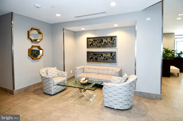 a living room with furniture and wall paintings