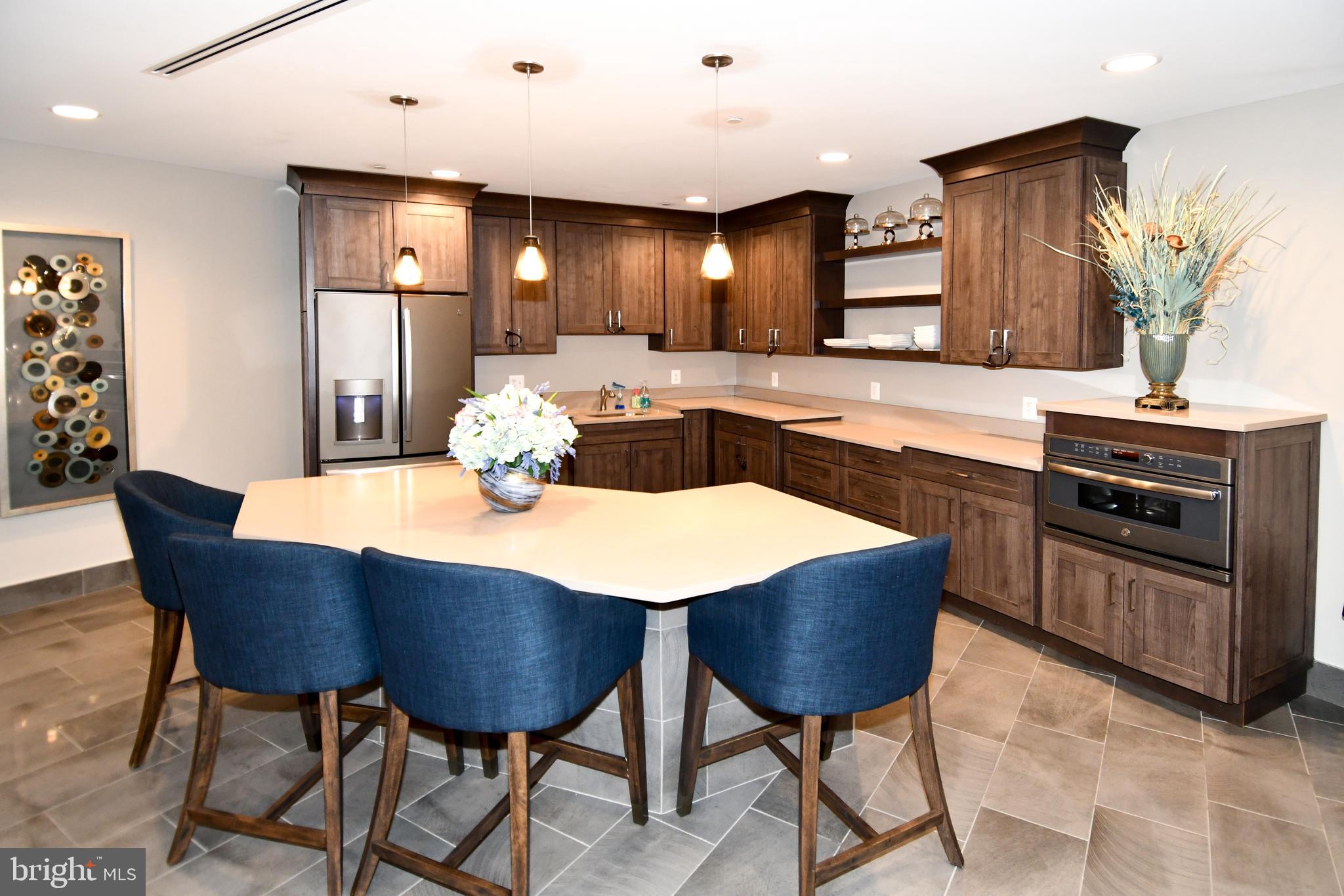 50 Florida Avenue Northeast, Unit 523 Washington, DC 20002 - Photo 35 of 38 a kitchen with stainless steel appliances granite countertop a kitchen island a table and chairs