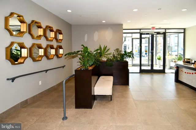 a lobby with a couch and potted plant