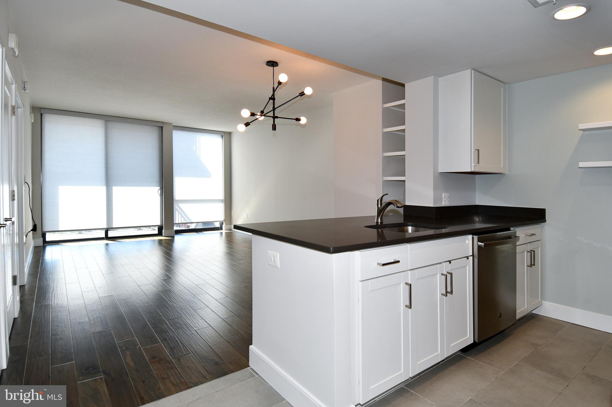 50 Florida Avenue Northeast, Unit 523 Washington, DC 20002 - Photo 4 of 38 a kitchen that has a sink a microwave and wooden floor